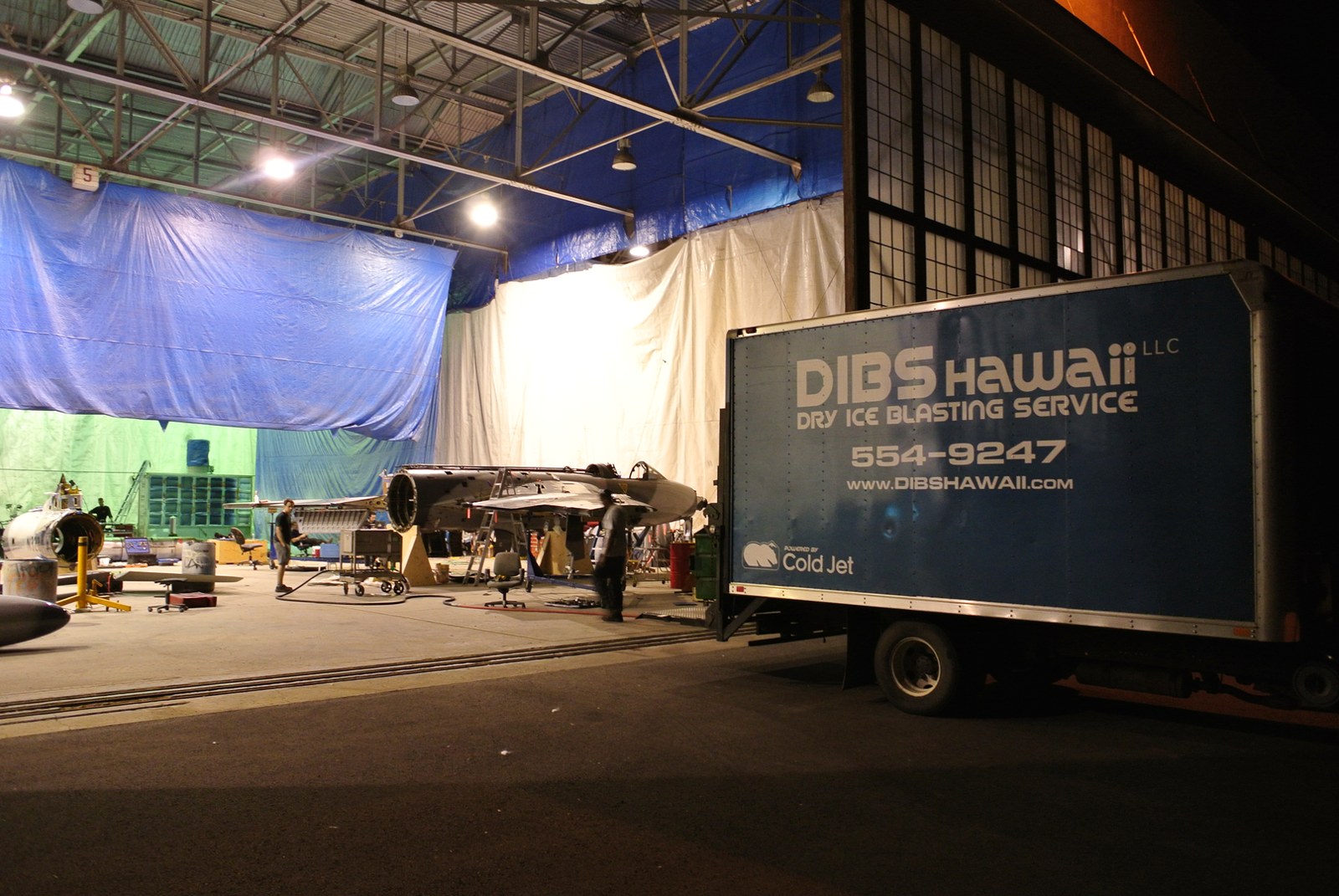 Dibshawaii dry ice blasting service truck staged inside an aircraft hangar during a containment job